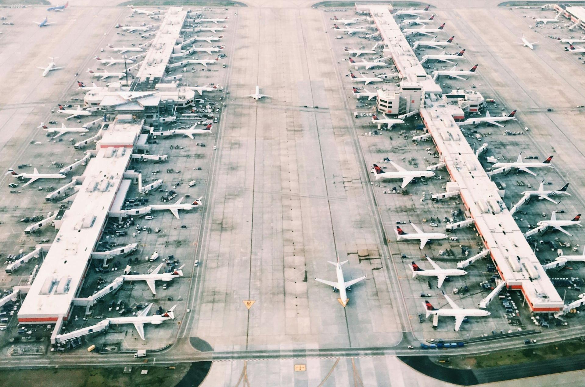 aerial view of airport with lots of airplanes during daytime